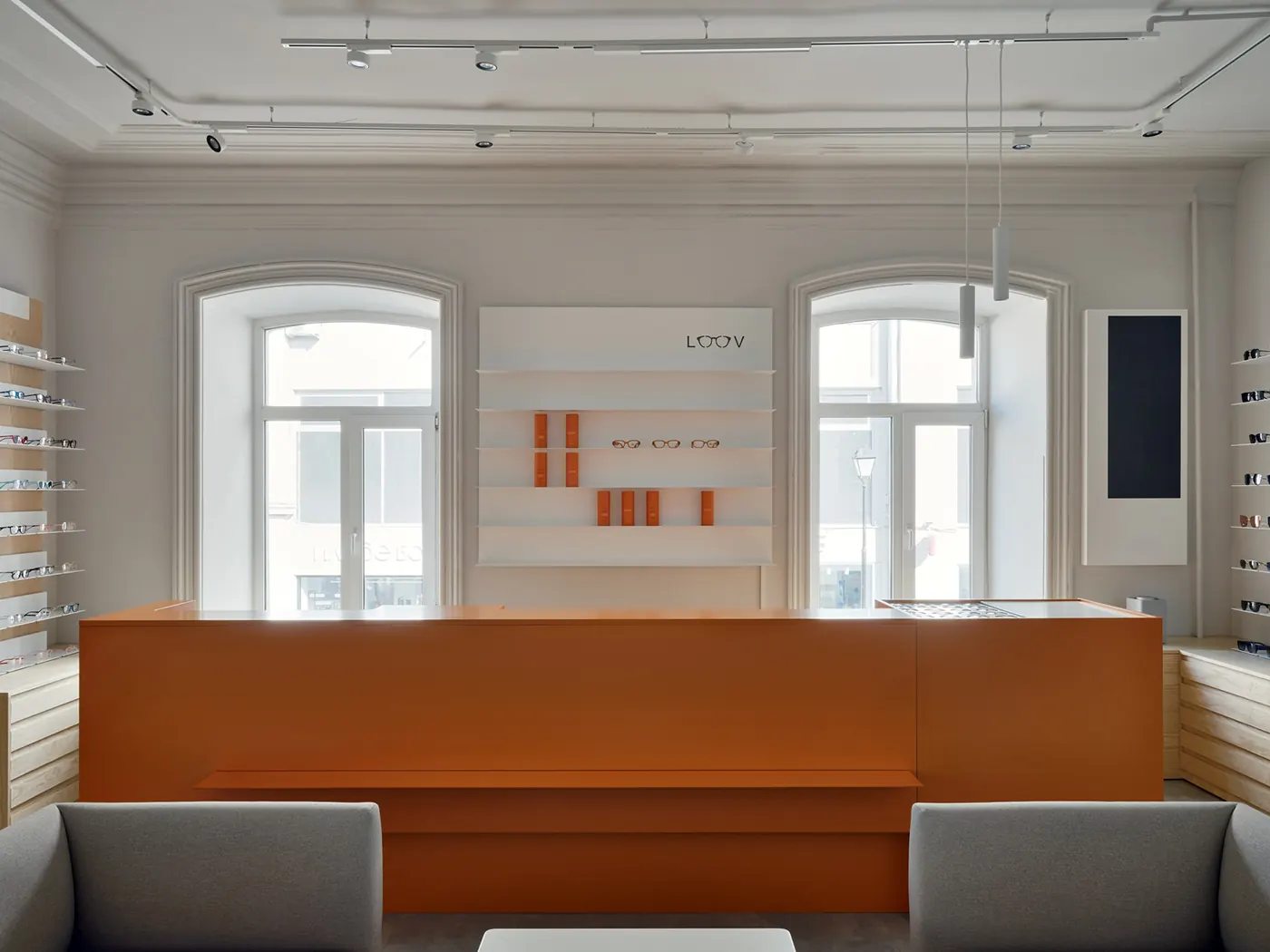 Minimal White Orange Eye Care Center fixture detail